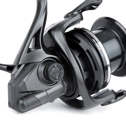 Close-up of a black fishing reel on a white background
