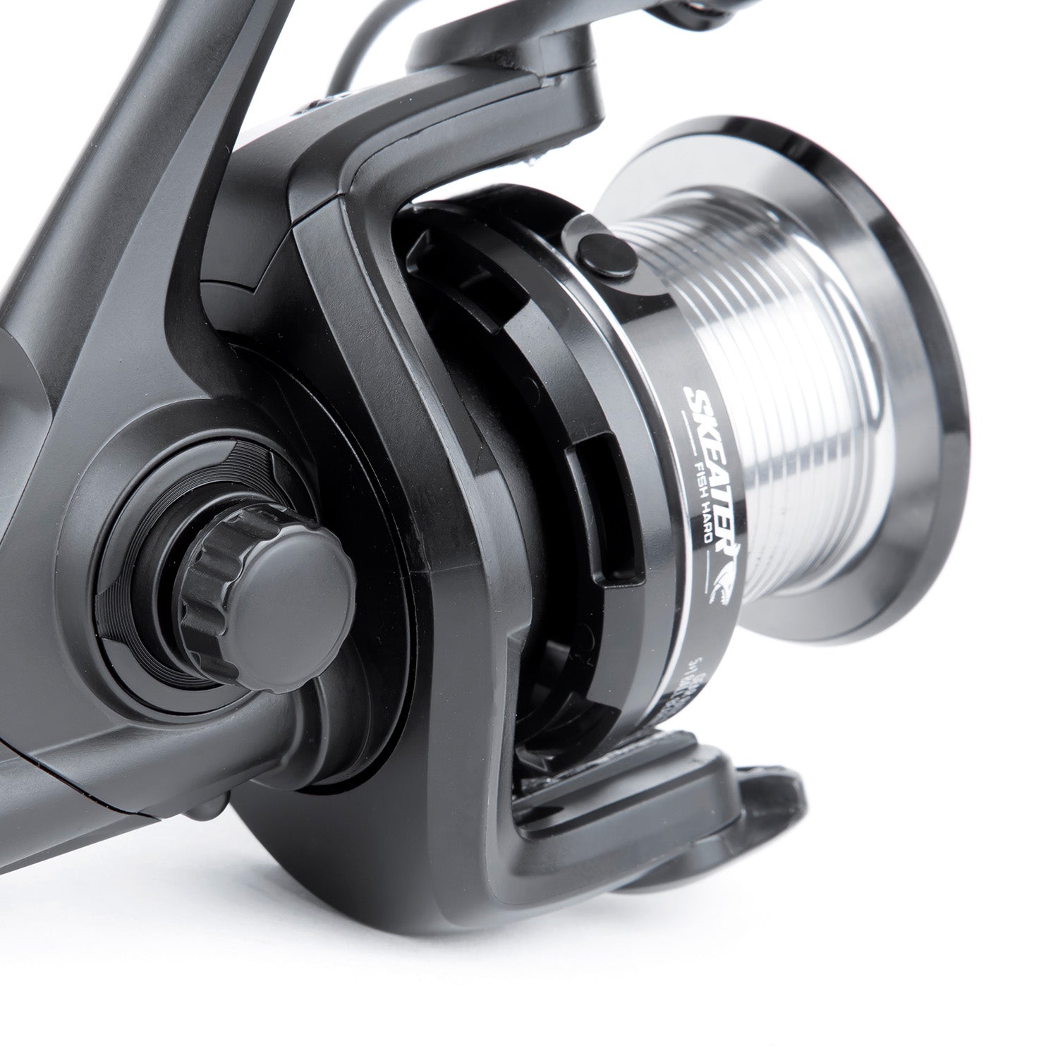 Close-up of a fishing reel with a white background