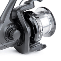 Close-up of a fishing reel with a white background